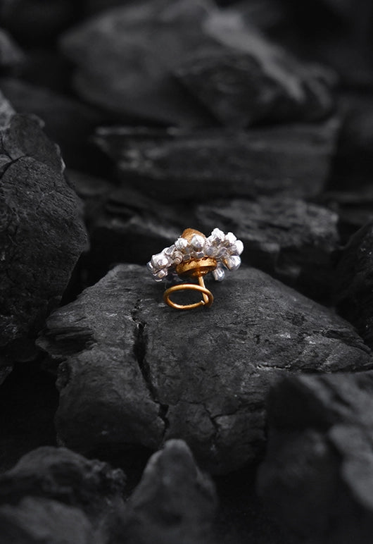 Banjara Nose Pin in 18-carat gold plating on sterling silver, product photo on black – nose pin, Bhavya Ramesh