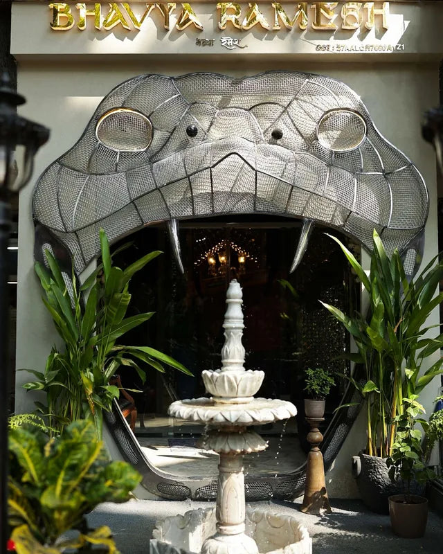 The silver serpent facade and the tiny fountain of the Bandra store