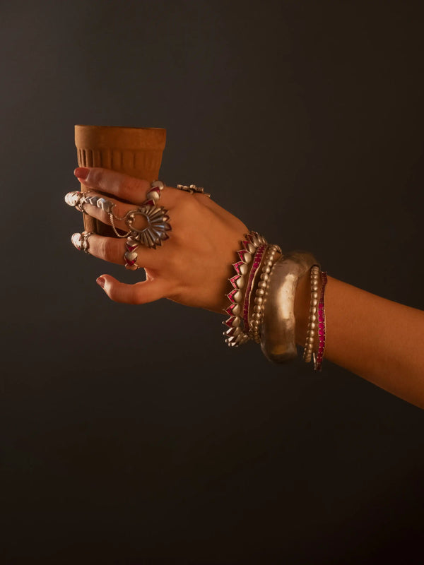 Boondi Bangle in sterling silver, product photo on black – bangle, Bhavya Ramesh