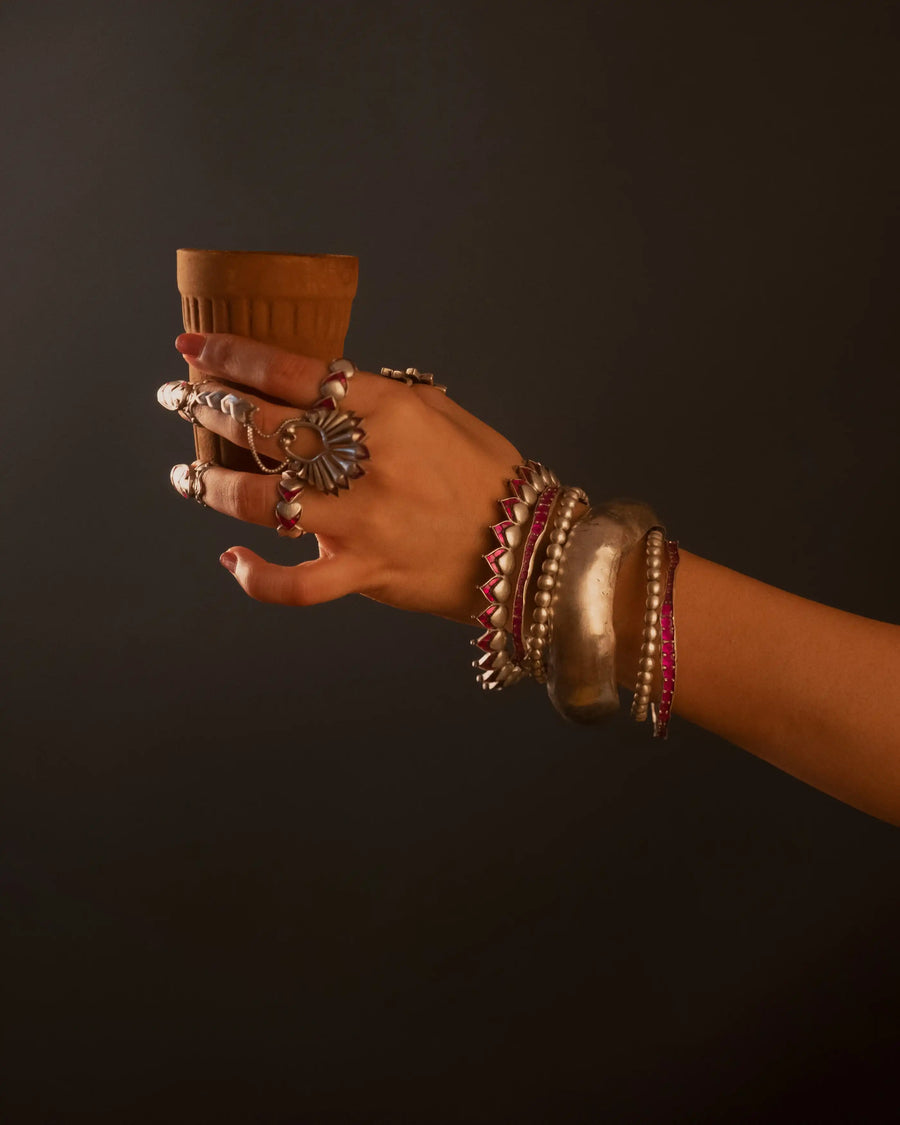 Boondi Bangle in sterling silver, product photo on black – bangle, Bhavya Ramesh
