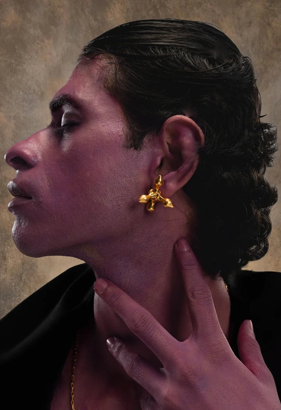 Crucifix earring in 18-carat gold plating on sterling silver, worn by a model – earrings, Bhavya Ramesh