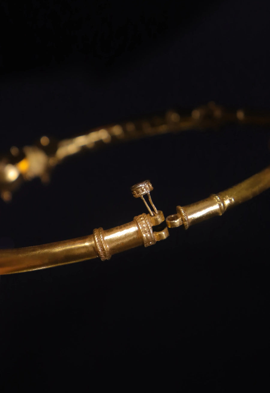 NityaNirvana in 18-carat gold plating on sterling silver, product photo on black – neck pieces, Bhavya Ramesh