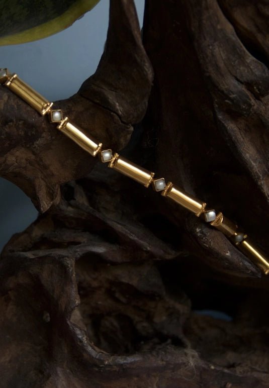 Radiate Bracelet in 18-carat gold plating on sterling silver, product photo on black – wrist wear, Bhavya Ramesh