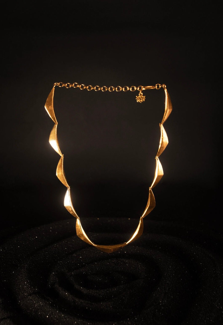 Vegavat Neckpiece in 18-carat gold plating on sterling silver, product photo on black – neck pieces, Bhavya Ramesh