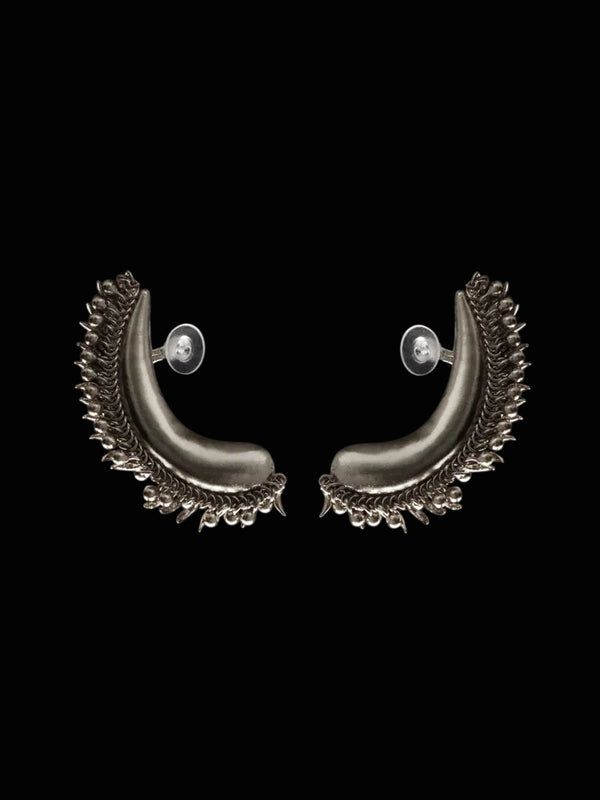 Tusk Earclips in sterling silver, product photo on black – ear clips, Bhavya Ramesh
