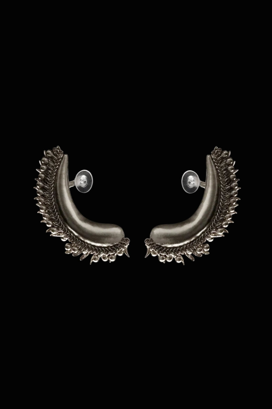 Tusk Earclips in sterling silver, product photo on black – ear clips, Bhavya Ramesh