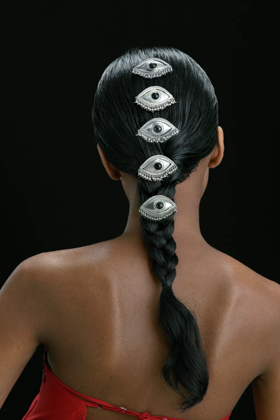 Gaze hair clips in sterling silver worn down a braid – five eye-shaped clips seen from behind, Bhavya Ramesh
