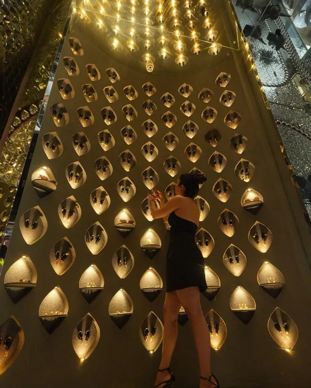 A visitor at the wall of sculpted ears in the Bandra store