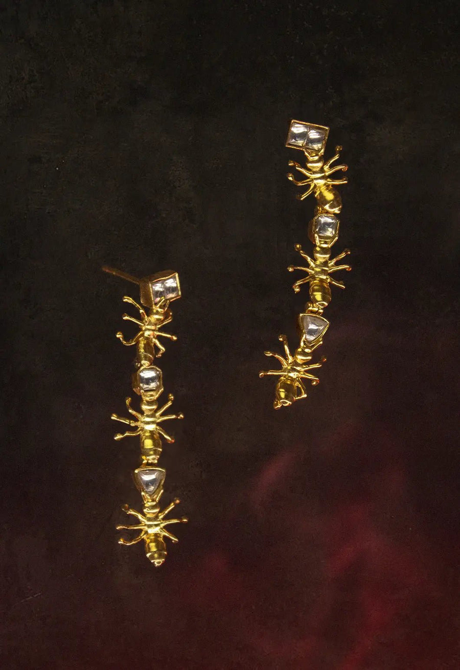 Insidious Earring in 18-carat gold plating on sterling silver, product photo on black – earrings, Bhavya Ramesh