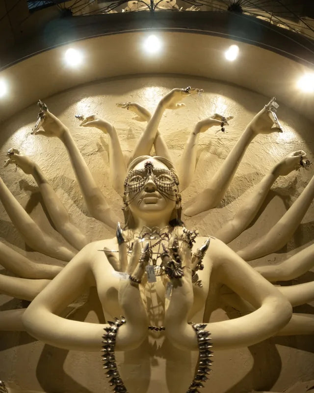 A many-armed figure of mudras, dressed in Bhavya Ramesh silver
