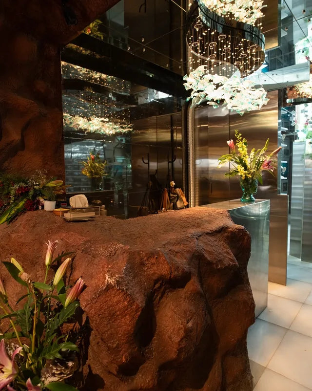 A rock-carved counter beside glass and light inside the Khan Market store