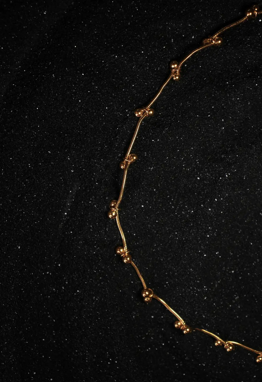Mankashi Neckpiece in 18-carat gold plating on sterling silver, product photo on black – neck pieces, Bhavya Ramesh