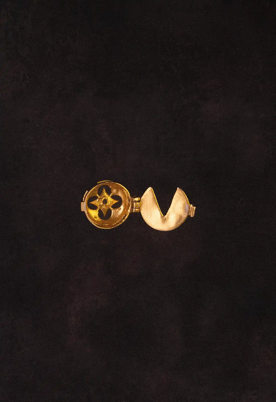 Oblivion Button Top in 18-carat gold plating on sterling silver, product photo on black – wrist wear, Bhavya Ramesh