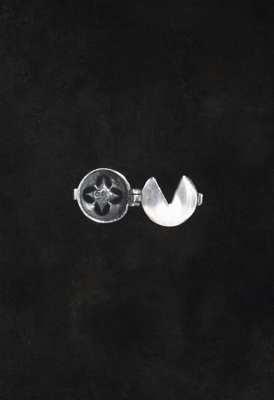 Oblivion Button Top in 925 sterling silver, product photo on black – wrist wear, Bhavya Ramesh