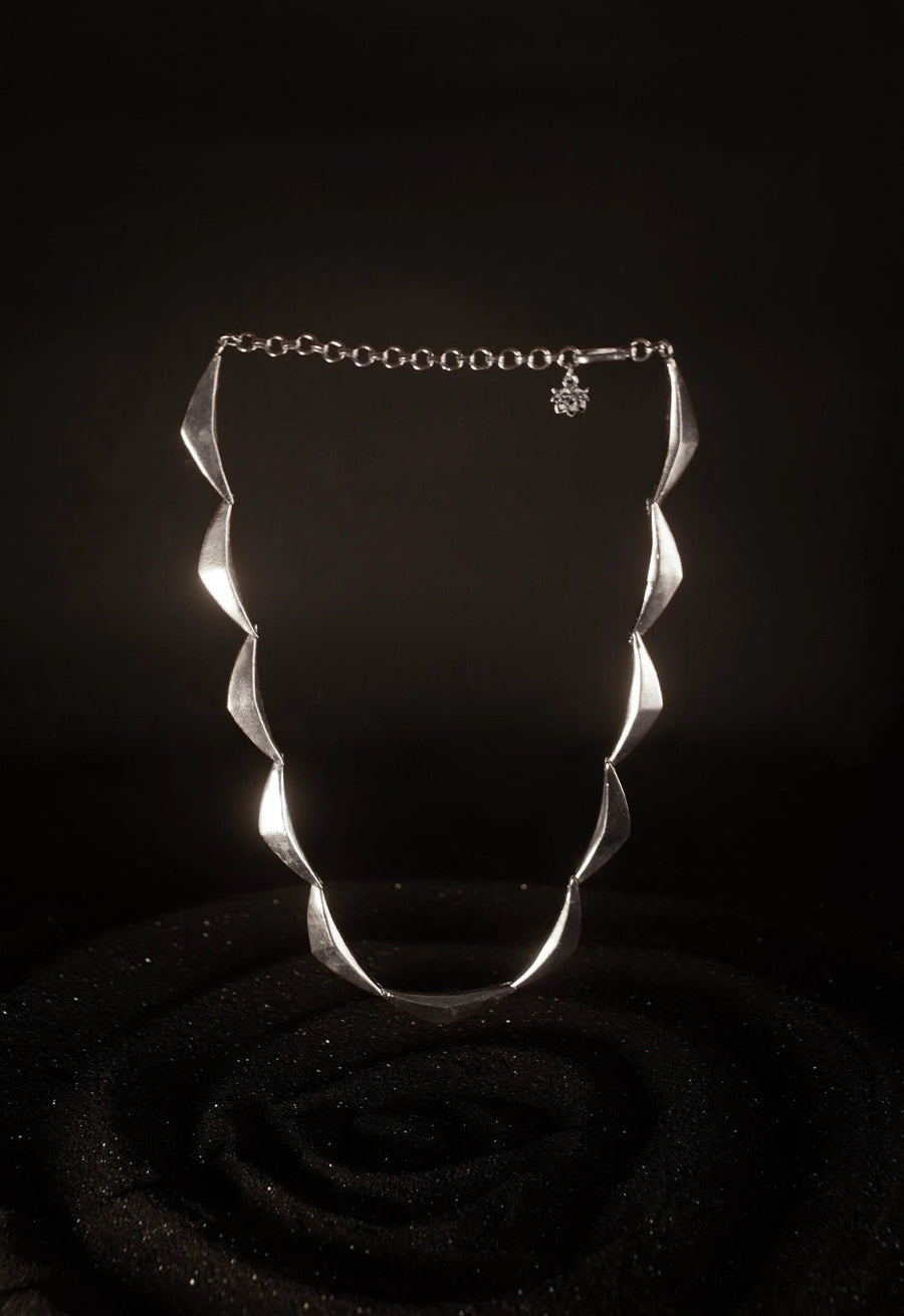Vegavat Neckpiece in 925 sterling silver, product photo on black – neck pieces, Bhavya Ramesh
